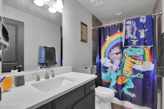 2982 N Bygone Way, Post Falls, ID 83854 - bathroom with toilet, visible vents, and vanity