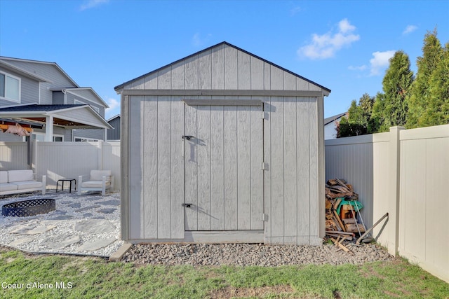2982 N Bygone Way, Post Falls, ID 83854 - view of shed featuring a fenced backyard and an outdoor fire pit