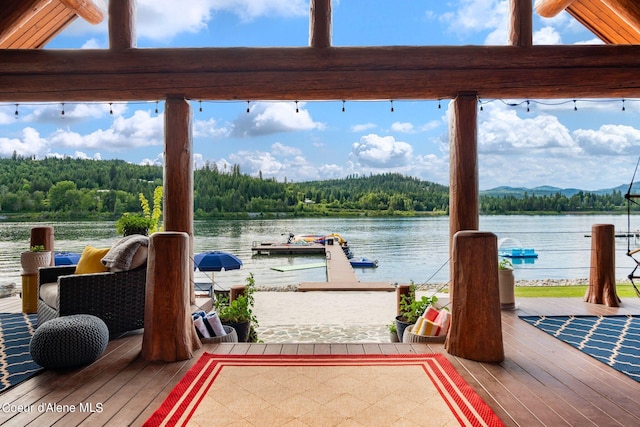 dock area with a view of trees and a water view