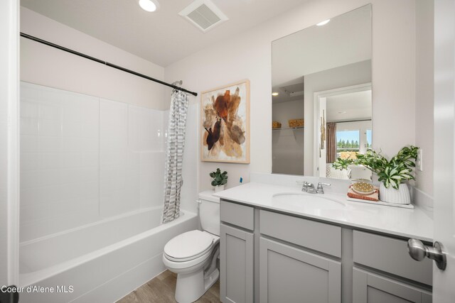 120 E Spirea Ln, Hayden, ID 83835 - bathroom with wood finished floors, vanity, shower / tub combo, toilet, and visible vents