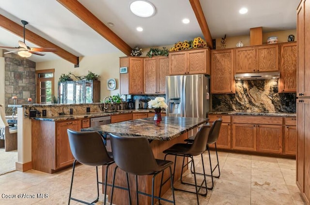 kitchen with stainless steel fridge with ice dispenser, decorative backsplash, and brown cabinets