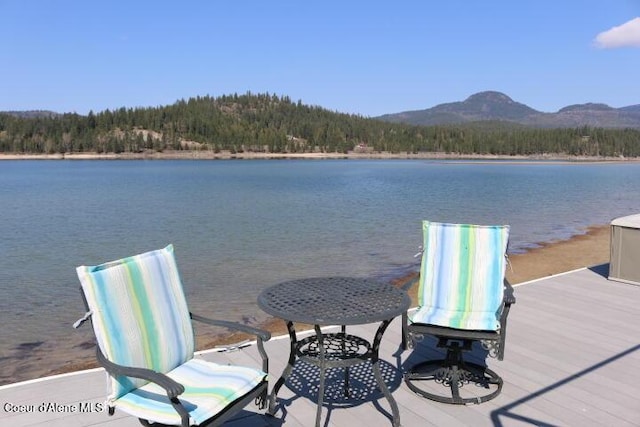 dock area featuring a water and mountain view and a forest view