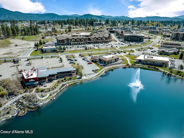 drone / aerial view featuring a water and mountain view