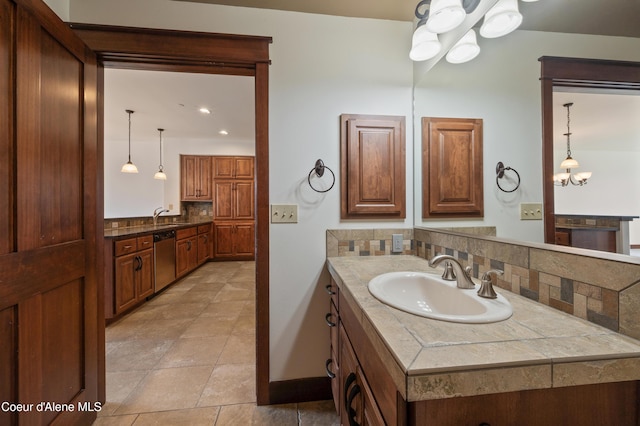 bathroom featuring an inviting chandelier, backsplash, and vanity