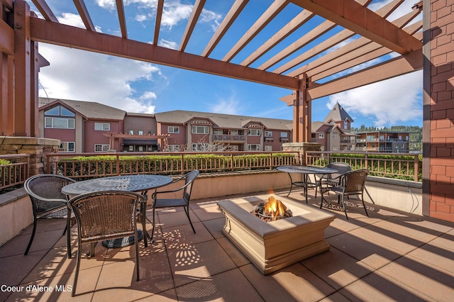view of patio / terrace featuring a residential view, a pergola, outdoor dining area, and a fire pit