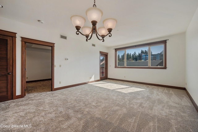 unfurnished room with visible vents, baseboards, an inviting chandelier, and light colored carpet