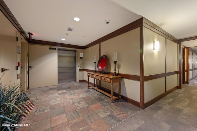 hall with visible vents, recessed lighting, baseboards, and elevator