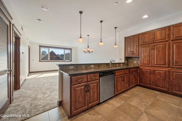 kitchen featuring decorative light fixtures, tasteful backsplash, stainless steel dishwasher, a sink, and a peninsula