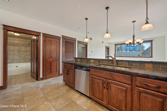 kitchen with stainless steel dishwasher, pendant lighting, a chandelier, a sink, and dark stone countertops