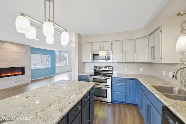 956 N Armstrong Dr, Coeur Dalene, ID 83814 - kitchen featuring appliances with stainless steel finishes, a sink, white cabinetry, and dark wood-type flooring