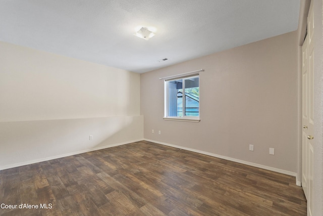 956 N Armstrong Dr, Coeur Dalene, ID 83814 - spare room featuring dark wood-type flooring and baseboards