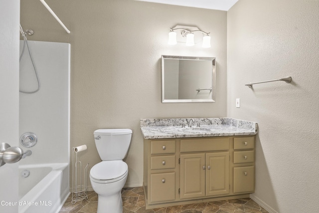 956 N Armstrong Dr, Coeur Dalene, ID 83814 - bathroom with vanity, bathtub / shower combination, toilet, baseboards, and stone finish flooring