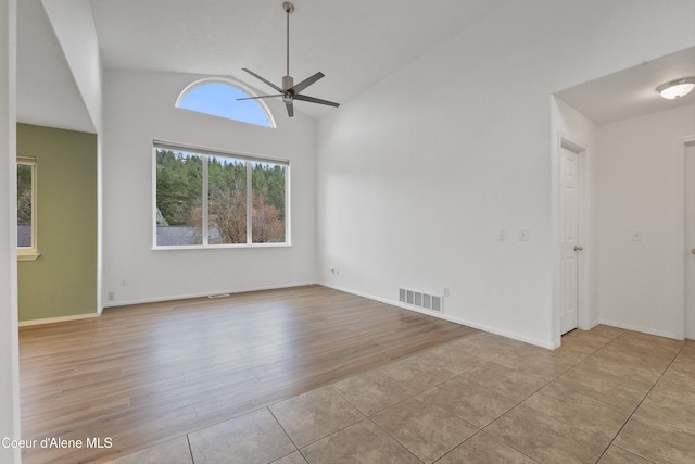956 N Armstrong Dr, Coeur Dalene, ID 83814 - spare room with ceiling fan, tile patterned flooring, and high vaulted ceiling