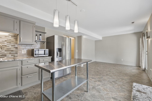 956 N Armstrong Dr, Coeur Dalene, ID 83814 - kitchen featuring open shelves, stone finish flooring, appliances with stainless steel finishes, tasteful backsplash, and gray cabinetry
