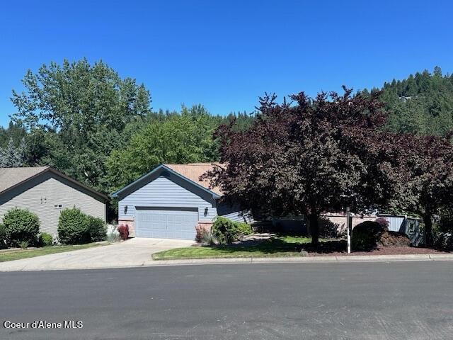 956 N Armstrong Dr, Coeur Dalene, ID 83814 - view of front of property with concrete driveway and an attached garage