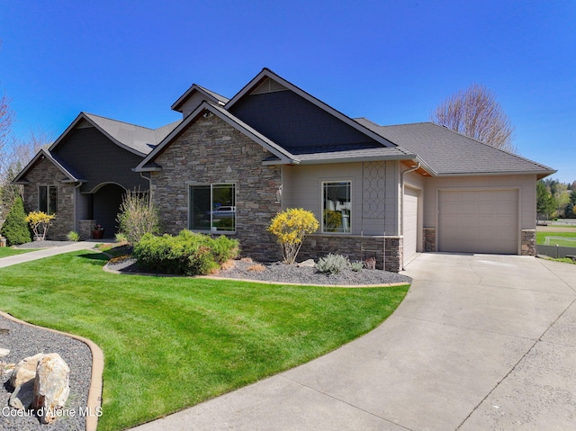 9024 N Baldwin Ct, Hayden, ID 83835 - view of front of house featuring a garage, a front yard, driveway, and stone siding