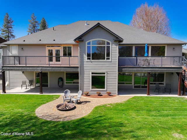 9024 N Baldwin Ct, Hayden, ID 83835 - rear view of house featuring a fire pit, a wooden deck, a patio, stairs, and a lawn