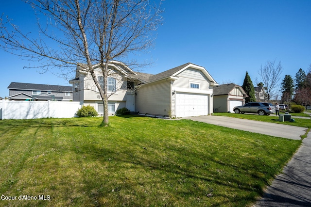split level home with a garage, fence, driveway, and a front yard