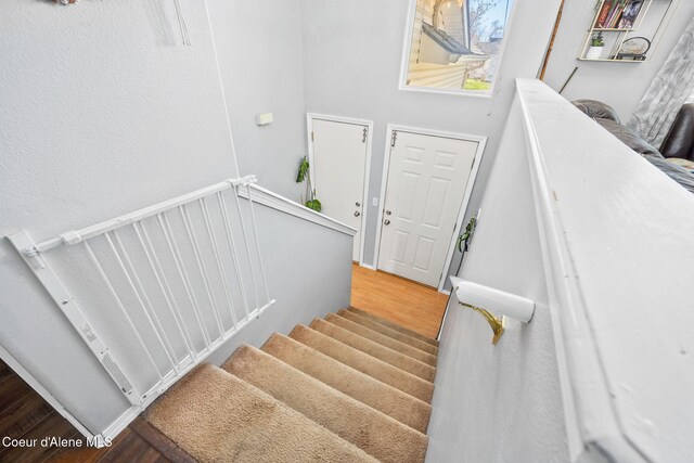 stairway with wood finished floors