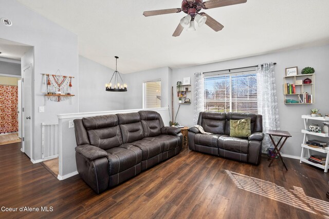 living room with baseboards, ceiling fan with notable chandelier, wood finished floors, and lofted ceiling
