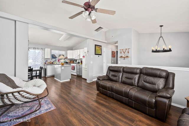 living area featuring ceiling fan with notable chandelier, visible vents, lofted ceiling, and dark wood-type flooring