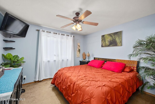 bedroom featuring baseboards, carpet flooring, and a ceiling fan