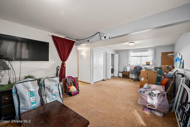 miscellaneous room featuring carpet flooring and washer / clothes dryer