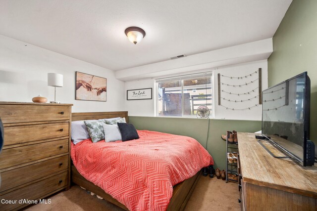 bedroom with visible vents and carpet