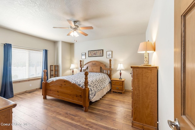 bedroom featuring baseboards, ceiling fan, and hardwood / wood-style floors