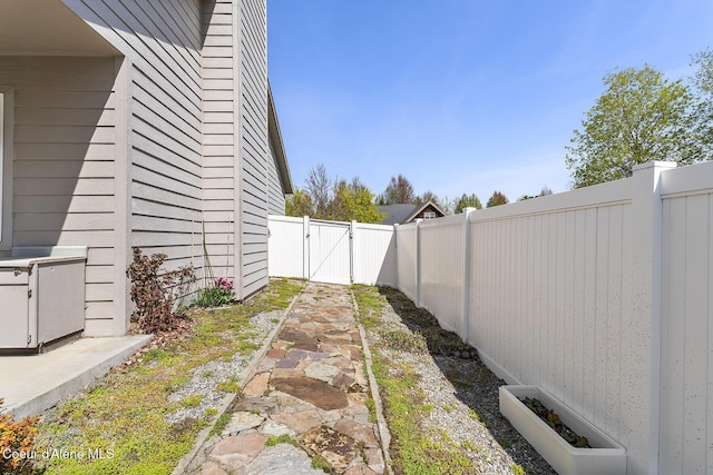 view of yard featuring a gate and a fenced backyard