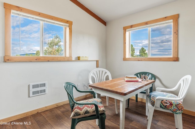 dining area featuring vaulted ceiling, heating unit, wood finished floors, and baseboards