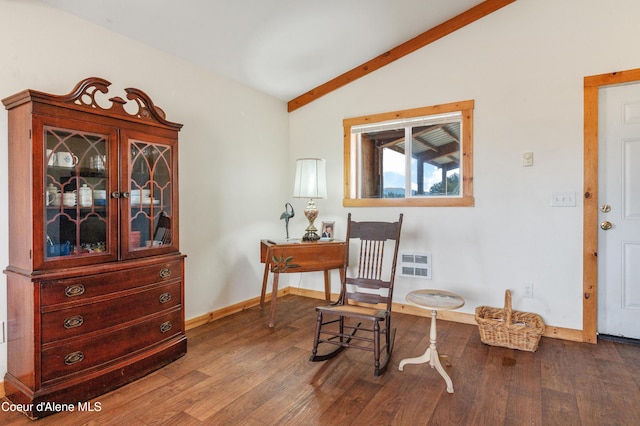sitting room with wood finished floors, vaulted ceiling with beams, and baseboards