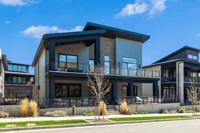 3132 N Atlas Rd, Coeur Dalene, ID 83814 - view of front of house featuring covered porch, stone siding, and a balcony