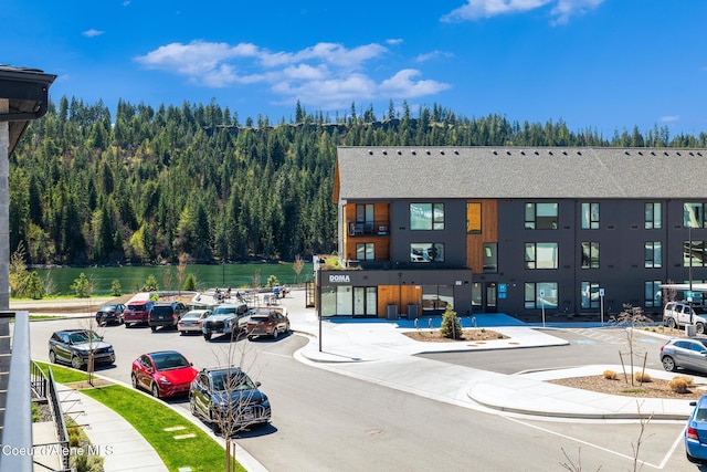 3132 N Atlas Rd, Coeur Dalene, ID 83814 - view of building exterior featuring a forest view and uncovered parking