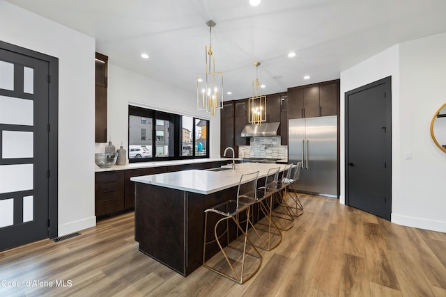 3132 N Atlas Rd, Coeur Dalene, ID 83814 - kitchen with a sink, dark brown cabinetry, stainless steel built in fridge, under cabinet range hood, and visible vents