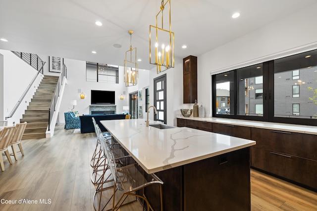 3132 N Atlas Rd, Coeur Dalene, ID 83814 - kitchen with light wood-style floors, modern cabinets, a kitchen breakfast bar, and a sink
