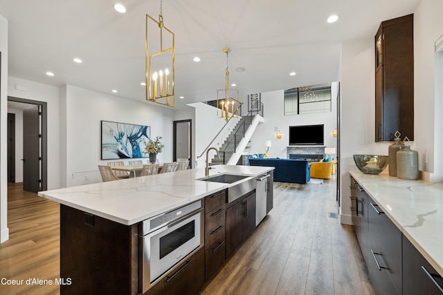 3132 N Atlas Rd, Coeur Dalene, ID 83814 - kitchen with dishwasher, open floor plan, a sink, and light wood finished floors