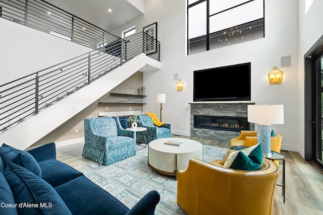 3132 N Atlas Rd, Coeur Dalene, ID 83814 - living room featuring stairway, baseboards, a towering ceiling, and wood finished floors
