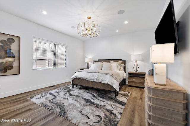 3132 N Atlas Rd, Coeur Dalene, ID 83814 - bedroom featuring recessed lighting, wood finished floors, baseboards, and an inviting chandelier