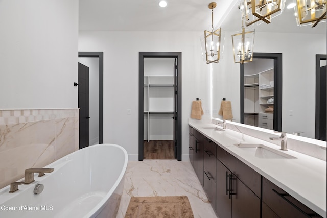 3132 N Atlas Rd, Coeur Dalene, ID 83814 - full bathroom featuring a sink, a walk in closet, a freestanding tub, a chandelier, and marble finish floor
