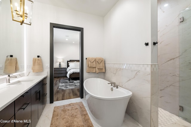 3132 N Atlas Rd, Coeur Dalene, ID 83814 - ensuite bathroom with vanity, a marble finish shower, tile walls, a freestanding tub, and ensuite bathroom