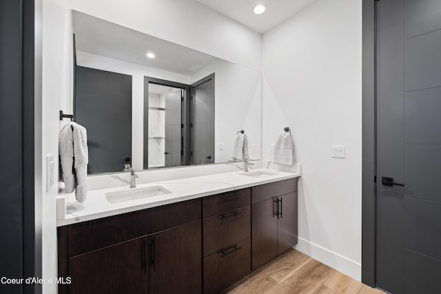 3132 N Atlas Rd, Coeur Dalene, ID 83814 - full bathroom featuring double vanity, wood finished floors, baseboards, and a sink