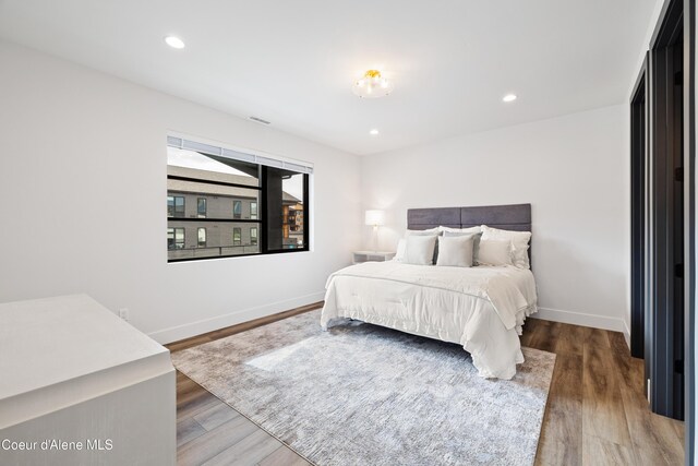 3132 N Atlas Rd, Coeur Dalene, ID 83814 - bedroom with visible vents, baseboards, wood finished floors, and recessed lighting