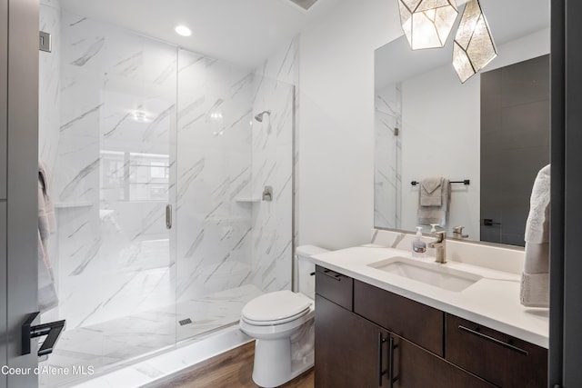 3132 N Atlas Rd, Coeur Dalene, ID 83814 - bathroom with wood finished floors, a marble finish shower, vanity, toilet, and recessed lighting