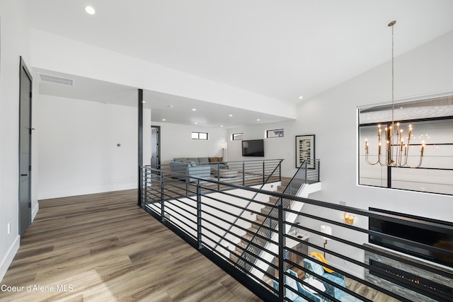 3132 N Atlas Rd, Coeur Dalene, ID 83814 - hall featuring wood finished floors, an upstairs landing, a notable chandelier, visible vents, and recessed lighting