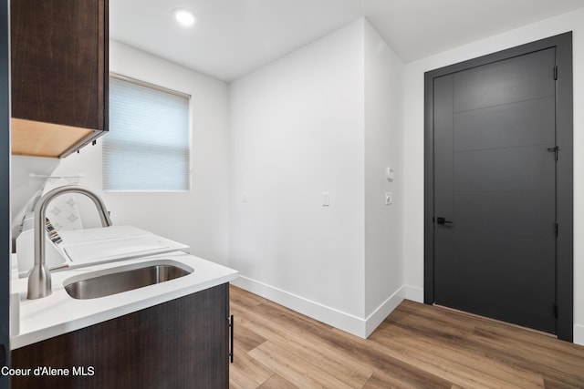 3132 N Atlas Rd, Coeur Dalene, ID 83814 - laundry area with a sink, cabinet space, light wood finished floors, baseboards, and recessed lighting
