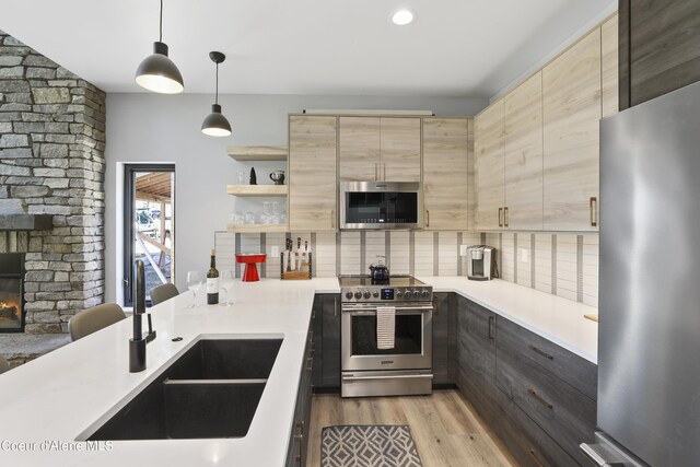 70 Wedge Ct, Priest Lake, ID 83856 - kitchen featuring light countertops, light brown cabinets, stainless steel appliances, and a sink