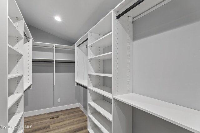 70 Wedge Ct, Priest Lake, ID 83856 - walk in closet with vaulted ceiling, wood finished floors, and visible vents