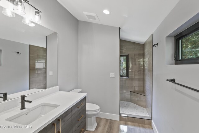 70 Wedge Ct, Priest Lake, ID 83856 - bathroom with wood finished floors, visible vents, baseboards, toilet, and a walk in shower