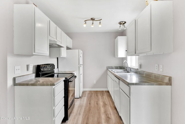 1002 E St Elias Ct, Post Falls, ID 83854 - kitchen with electric range, under cabinet range hood, stainless steel counters, light wood finished floors, and a sink